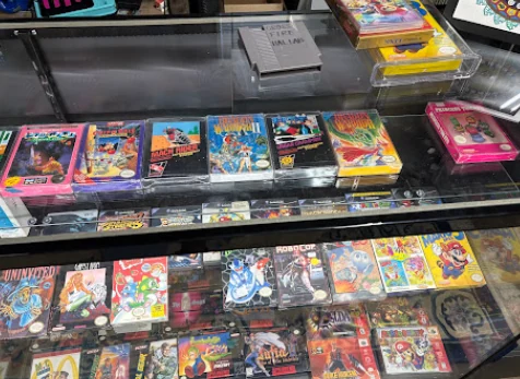 Glass display case of boxed and protected NES cartridges
